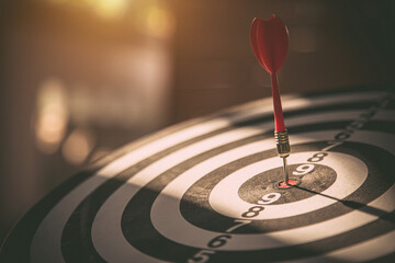 Bullseye target goal or dartboard has dart arrow throw hitting center shooting for financial...