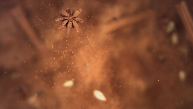 Cinnamon Sticks and Powder with Spices Flying and Falling in Slow Motion
