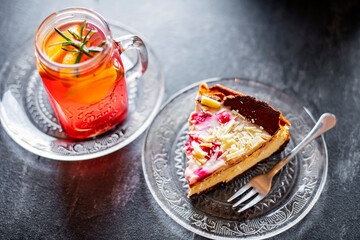 Cheesecake and a glass with hot fruit drink