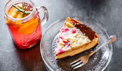 Cheesecake and a glass with hot fruit drink
