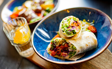 A bowl with two pieces of vegetarian tortilla
