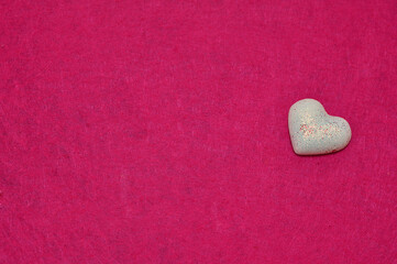 Fototapeta premium A white heart isolated on a pink background