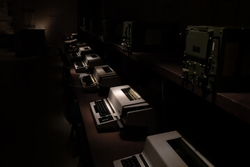 Old type writers in a dark bunker control room from the cold war era. Close up images with shallow...
