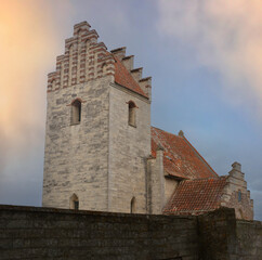 Fototapeta na wymiar Idyllic medieval church or chapel in warm bright evening light.