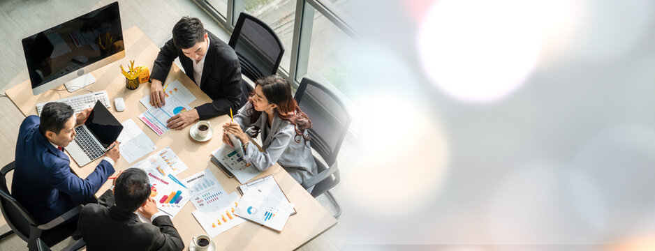 Business people group meeting shot from top widen view in office . Profession businesswomen, businessmen and office workers working in team conference with project planning document on meeting table .