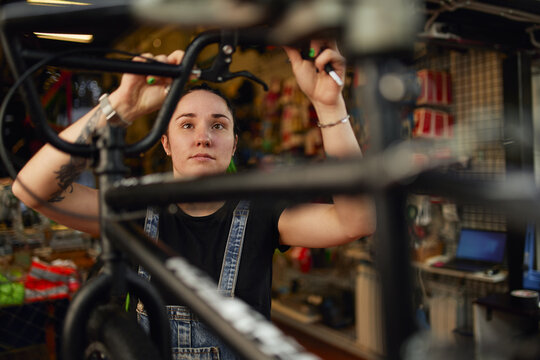 Master repairing handlebar of bike in workshop - Powered by Adobe