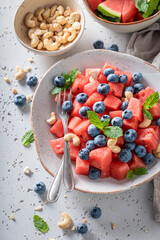 Juicy watermelon salad with blueberries and cashew nuts.