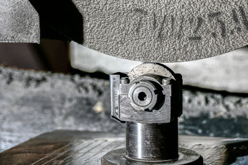 Abrasive grinding stone on a surface grinder with the correct cone installed before cleaning the wheel from sticking and leveling the roughing plane.