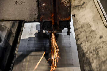 Grinding a metal part on a surface grinder.