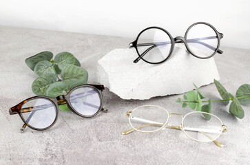 Glasses for vision of different types on a concrete background.
