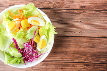 Fresh salad top view on gray wooden table