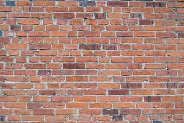 red brick wall, assembled from the remains of different colors
