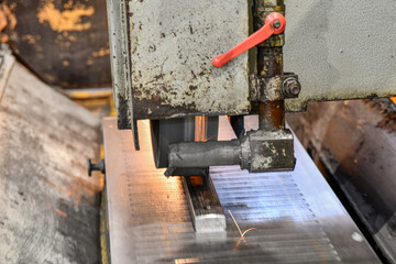 Grinding operations on a surface grinder, metal processing with an abrasive stone with sparks.