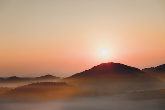 Beautiful sunrise landscape of  amazing mountain in fog.