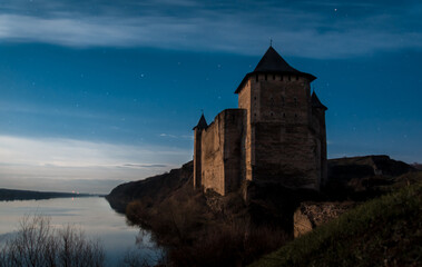 castle on the hillat the moonlight. castle in Khotyn on the river Dnister