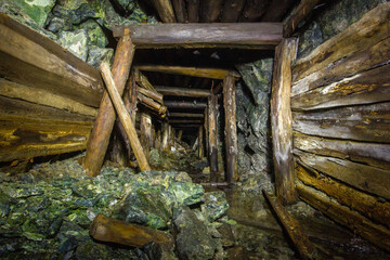Underground gold mine tunnel with wooden timbering