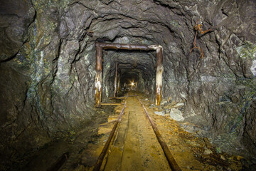 Underground gold mine tunnel with wooden timbering