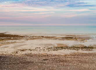 Normandy seascape, gorgeous pastel colors during low tide at sunset, northern France
