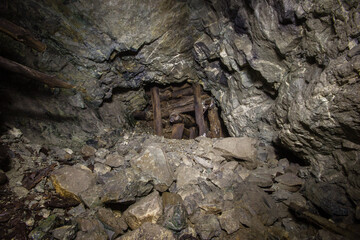 Underground gold mine tunnel with wooden timbering