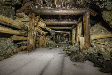Underground gold mine tunnel with wooden timbering