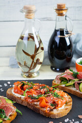 Grilled bruschetta with salmon fillet and jamon. Delicious Italian bruschetta antipasti