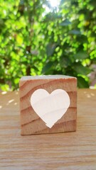 Conceptual of white heart. A heart shape in wooden cube