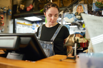 Woman working at counter in shop