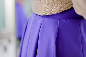 The first fitting of a skirt. Skirt in a fold, basting seams. 