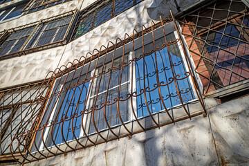 Metal grilles are installed on the windows of the house