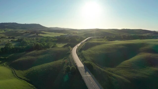 drone shot at sunset of the famous cypresses from Val d'Orcia in Tuscany, Italy. drone flying forward