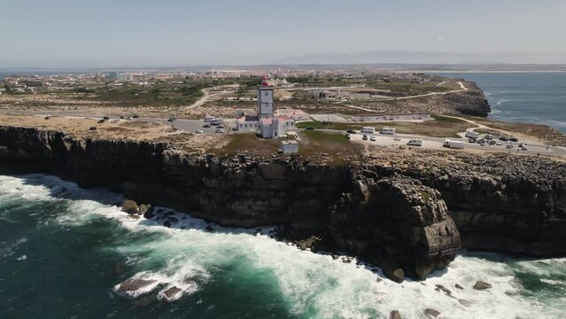 Nau dos Corvos or Ship of Crows and lighthouse, Carvoeiro cape, Peniche in Portugal. Aerial forward