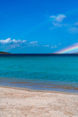 Tavolara Island, scenic view of island and full rainbow in a unique moment