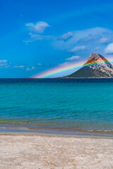 Tavolara Island, scenic view of island and full rainbow in a unique moment