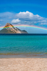 Tavolara Island, scenic view of island and full rainbow in a unique moment