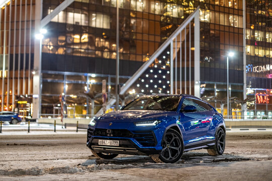 Moscow, russia - December 13, 2020: premium crossover lamborghini urus stand city road in night downtown city