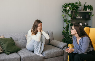 a frustrated female patient is sitting on the couch in the psychologist's office. The psychologist...