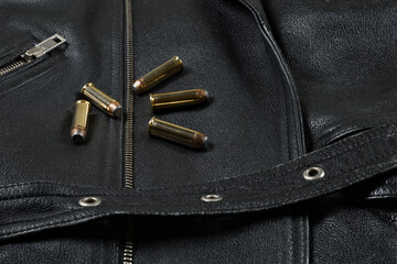 44 magnum ammunition, black leather jacket, belt,  closeup