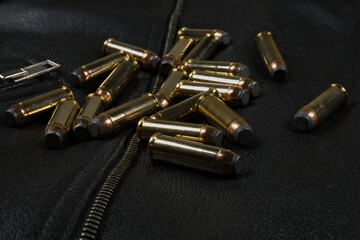 44 magnum ammunition, black leather jacket closeup