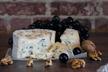Gorgonzola blue mold cheese with grapes and nuts.