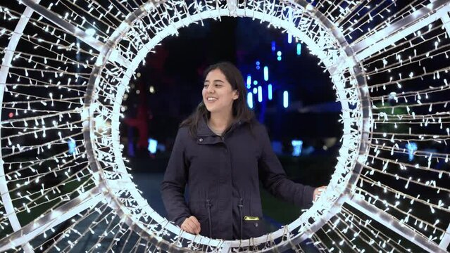 Beautiful happy girl in the middle of a circle of lights 