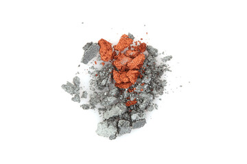 Crumble and crushe pearl gray and bronze eyeshadows, powder. Broken cosmetics on white background..