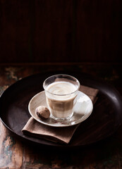 Coffee with milk on dark background. Soft focus. Copy space.