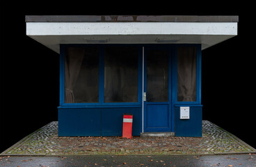 blue closed gatehouse isolated on black background, many factories remain empty due to the...