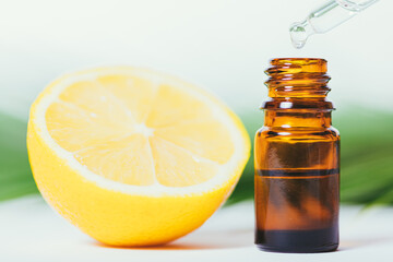 Lemon essential oil dripping into bottle with dropper