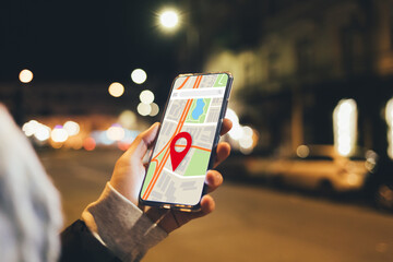 Woman using map application in smartphone to navigate city