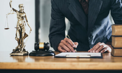 Attorneys sign legal documents in office.