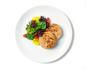 Fish cutlets with a vegetables  served on the white plate isolated on white background. Top view