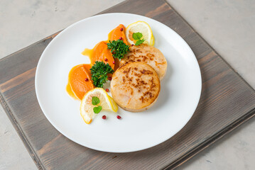 Fish cutlets with a vegetables  puree served whit lemon slice on the white plate