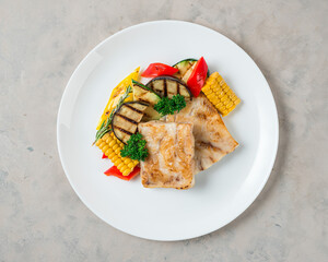 Roasted Fish fillet with grilled vegetables  on the white plate