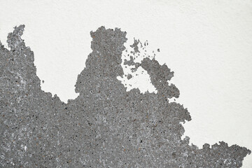 Closeup of peeling painted wall. Peeling white paint on the concrete wall.